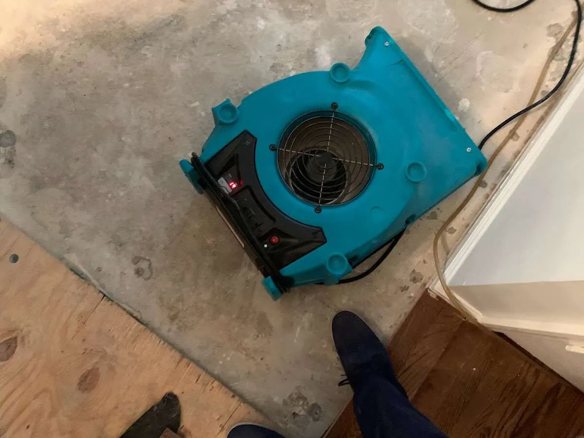 Air mover drying subfloor during Commercial Water Damage Restoration in Waterville